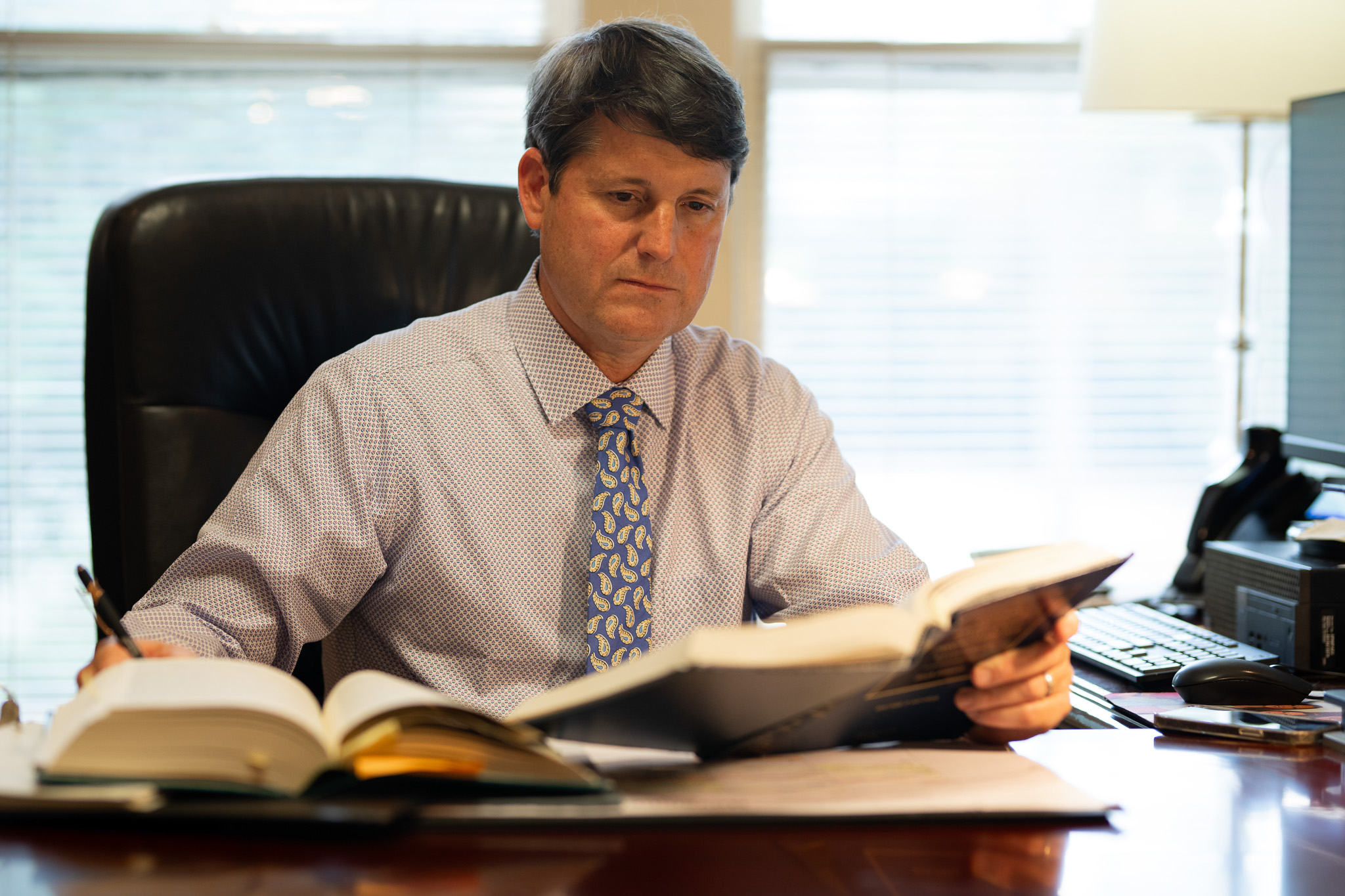 Carrollton attorney Met Lane reviewing case files at his desk