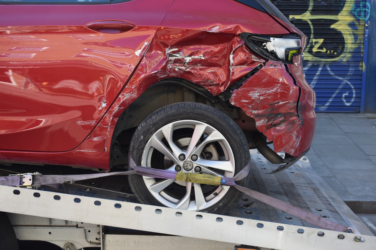 A damaged car loaded onto a flatbed tow truck after a Georgia accident